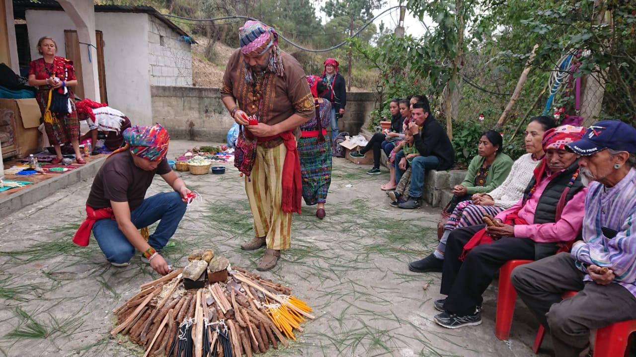 People gathered in a circle during a spiritual ceremony.